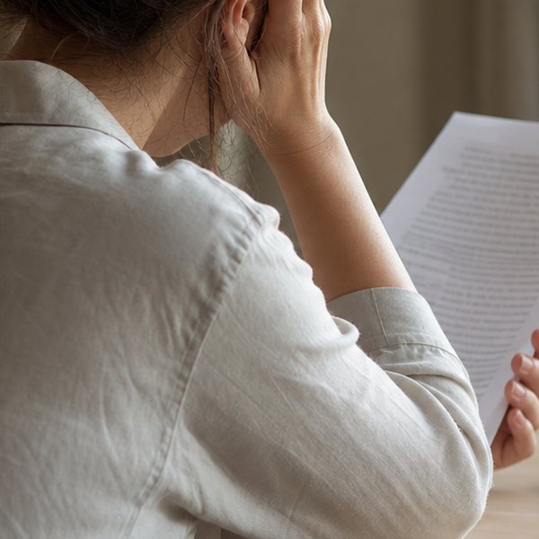 Person reading boring technical document — detail